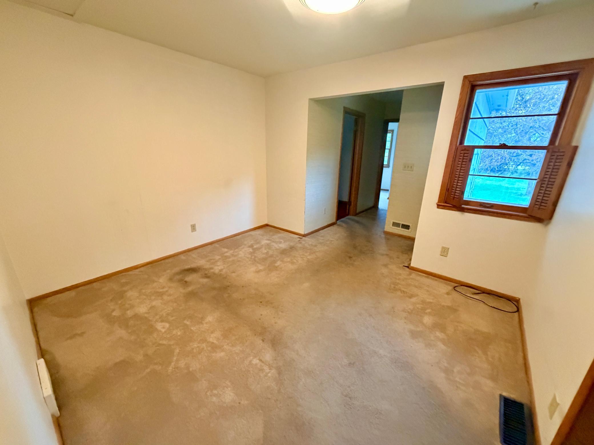The flexible main level den area between the kitchen and bedrooms 3 and 4 was previously used as a TV room but could also serve as a library, craft space, or study space.