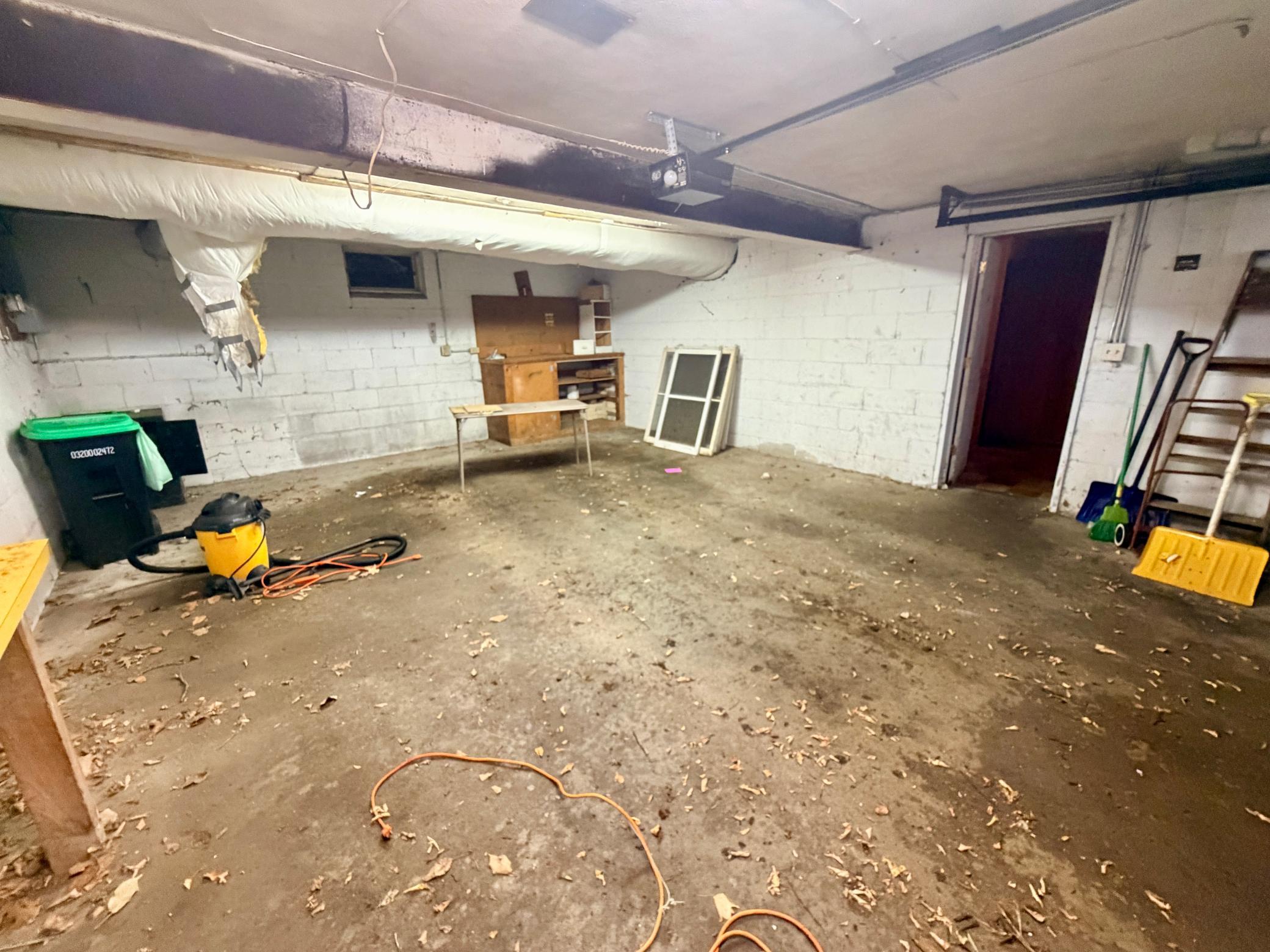 Two car tuck-under garage with a workbench and insulated duct work.