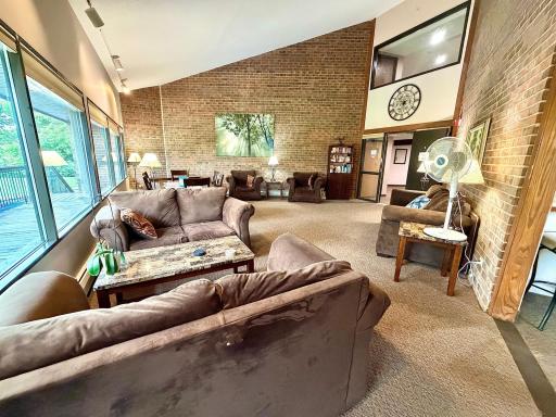 Relax and enjoy the vaulted community room with access to outdoor balcony deck space.jpg