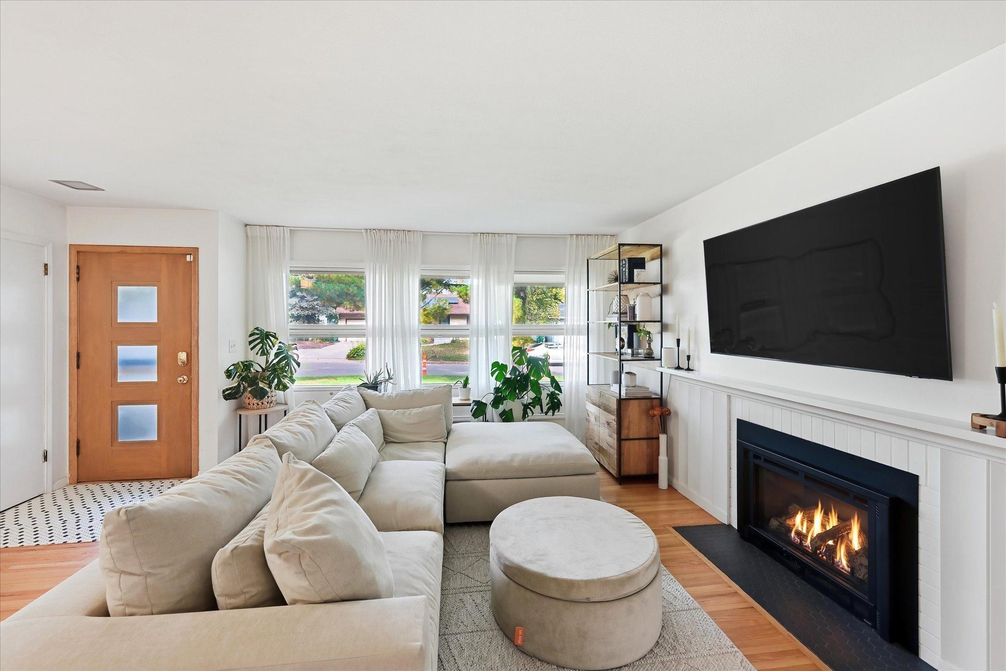 Living room light and bright with gas fireplace and real hardwood floor throughout the home!