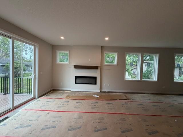 Cozy fireplace, open to a stunning kitchen and 10' center kitchen island Perfect for entertaining! Plus 9' wide patio door to Deck included!