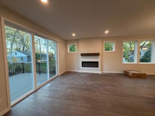 Spacious gathering room with cozy fireplace, 9' wide patio door to beautiful low-maintenance deck!