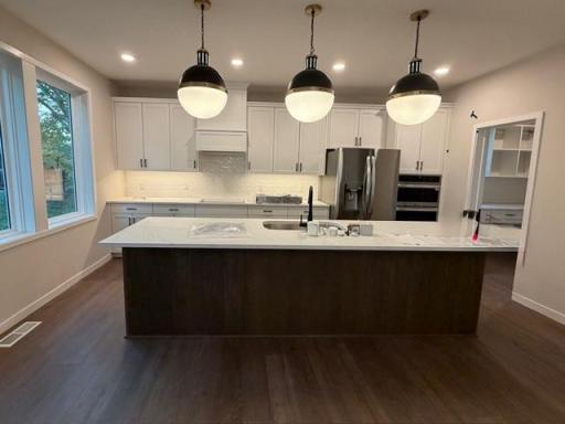 Stunning kitchen with a 10' center island kitchen island, wall ovens, gas cooktop and box hood! And you will also love our super-sized Morning Kitchen pantry!....