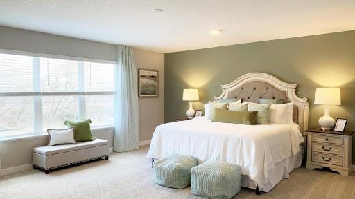 Likely one of the largest bedrooms found in new construction. Private walk-in closet and bath attached with dual vanities, tiled shower and soaking tub. Photo of model home, colors and finishes vary.