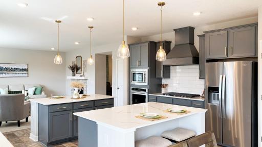 Spacious main floor with gourmet kitchen. Double island! Photo of model home, colors and finishes vary.