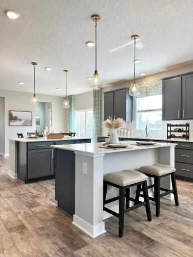 A must see kitchen with 2 center islands. Perfect for the chef in your home, entertaining and everyday living. Photo of model home, colors and finishes vary.