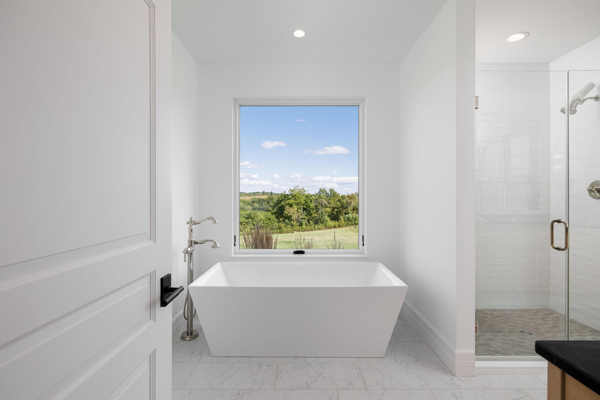 17 Primary Bath Soaking Tub with a Window to the World.jpg