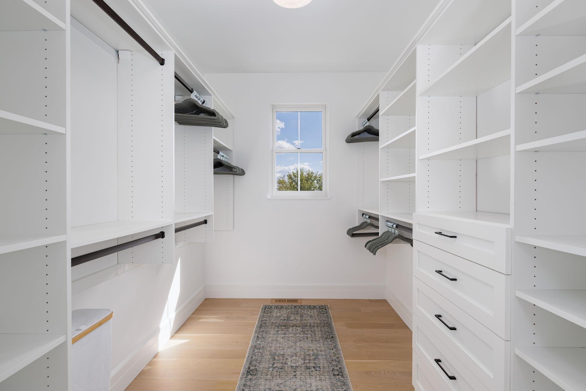 20 Spacious Primary Walk-In Closet with Custom Built-Ins.jpg