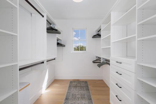 20 Spacious Primary Walk-In Closet with Custom Built-Ins.jpg