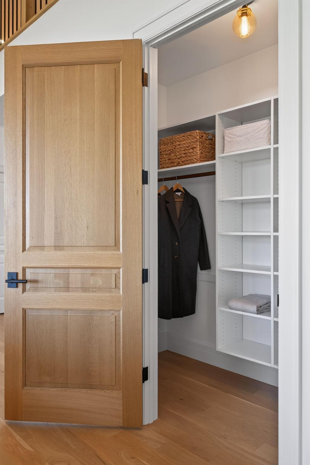 23 Walk-In Entry Closet with Custom Built-Ins & 8 Ft. Oak Door.jpg