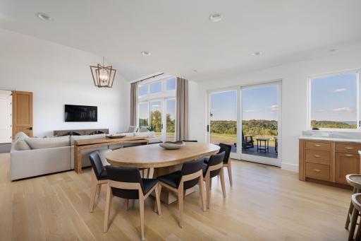 13 Dining Area with Wall of Windows and Views Toward the Expansive Deck.jpg
