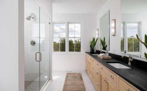 18 Primary Bath with Walk-In Tile Shower & Bluff Country Views.jpg