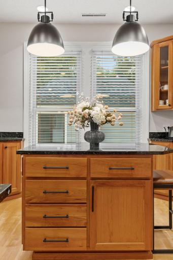 Elegant and multi-functional the island creates food prep and seating space perfect