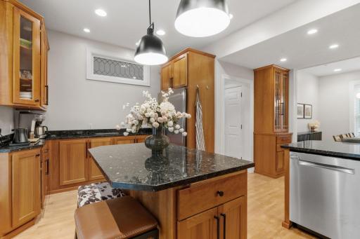 Gourmet kitchen featuring beverage bar, island, snack bar and buffet storage area