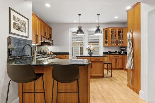 Gourmet kitchen with deluxe cabinetry, new cabinet door pulls, granite countertops and ample storage and prep space
