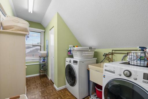 Laundry room is conveniently located by the primary bedroom