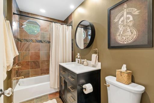 Main level full bathroom with exquisite tile accents