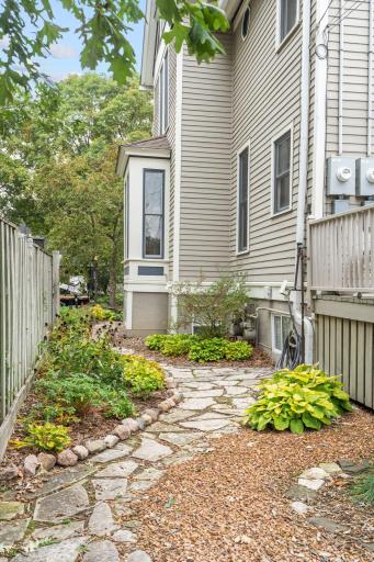 View of West side of building with lovely paver walking path