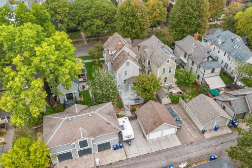 Aerial view of property showing alley, garage, extra parking and backyard exterior of home
