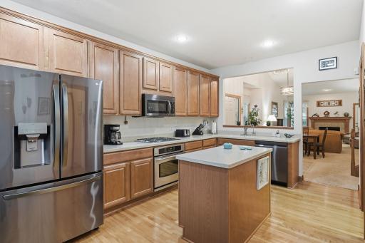 Well appointed kitchen features stainless appliances, ample cabinetry, and a center island for additional prep space.