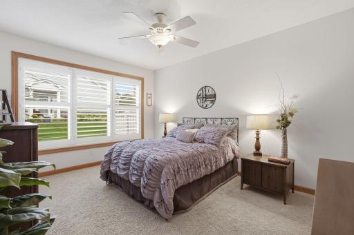 Large windows fill the primary bedroom with natural light.