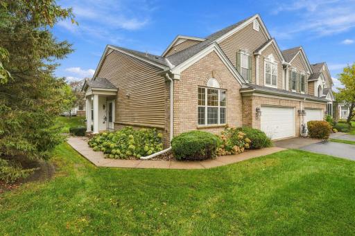 End unit townhome with with additional green space along the side yard.
