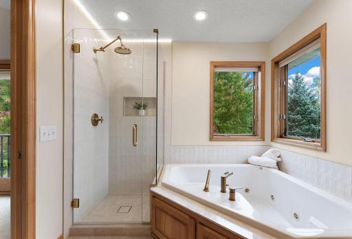 Brand new glass enclosure, new faucets, ceramic tile inside the shower and surrounding the tub walls, real marble surround on the bathtub and more