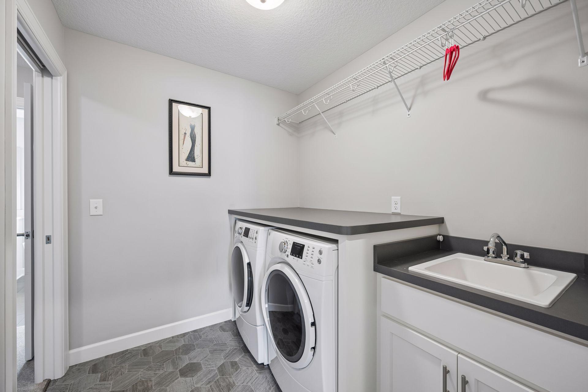 Upper level laundry with sink/cabinet and folding area