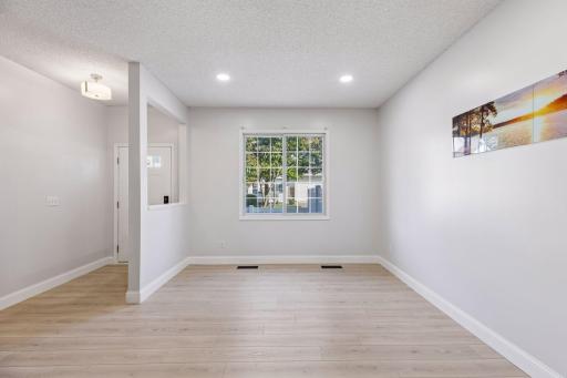 The open and airy living room is filled with natural light, making it a warm and comfortable gathering space.