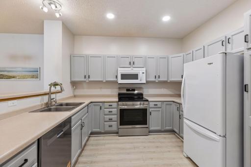 The beautifully updated kitchen features freshly painted cabinets that enhance its modern and stylish look.