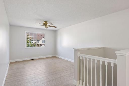 The upper level is filled with natural light, making the space feel open, airy, and inviting.