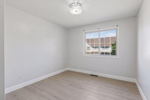 The second upstairs bedroom is bright, spacious, and offers plenty of versatility.
