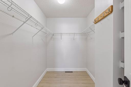 Primary bedroom walk in closet