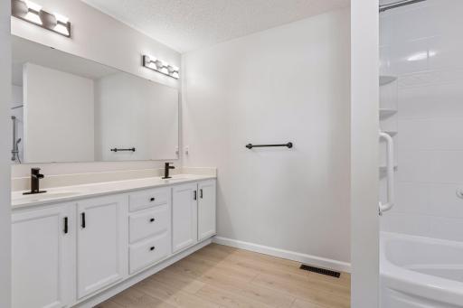 The beautiful vanity in the upper-level bathroom adds a sleek and sophisticated touch.