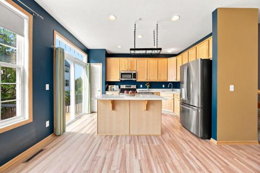 Kitchen includes stainless-steel appliances, pantry, and quartz counters.