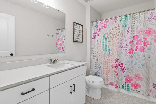 Upper level full bathroom with quartz counters and extended countertop space