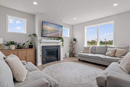 A spacious living room with gas fireplace is the gathering point in the open main floor layout