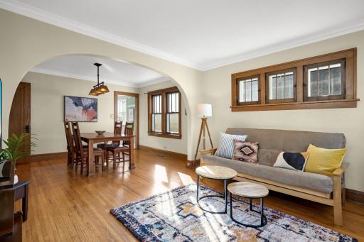 Piano windows in the living room and an archway separating the living and dining rooms