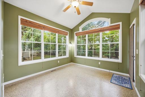 Wow! Light filled sun room that walks out to a private patio space.