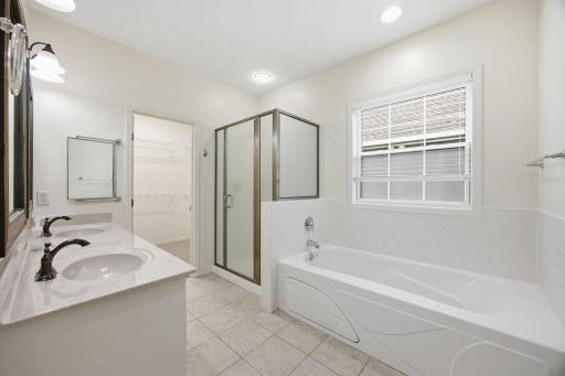 Huge primary bathroom with separate tub and shower.