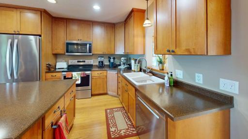 Well-designed kitchen offers abundant cabinetry and counter space, and a functional layout that makes entertaining a breeze.