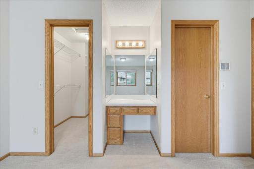 Primary bedroom has a walk in closet, a dressing vanity with 3 side mirrors, plus a walk thru to the full bath