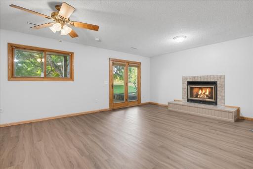 Family room showing nice fireplace with hearth, and walkout to patio