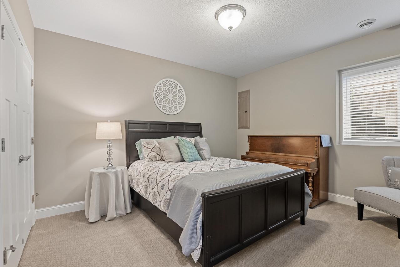 Lower-level fifth bedroom offering a comfortable, private space ideal for guests.