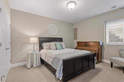 Lower-level fifth bedroom offering a comfortable, private space ideal for guests.