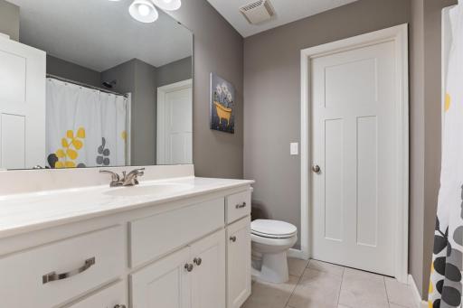 En-suite bathroom for Bedroom 2 featuring direct access to the spacious walk-in closet.
