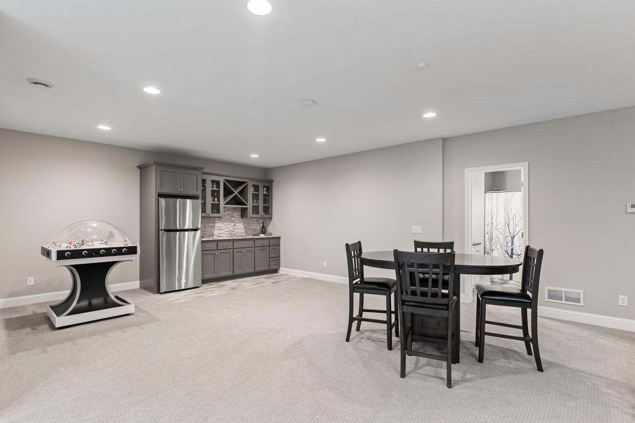 Built-in wet bar featuring ample storage and a convenient refrigerator.