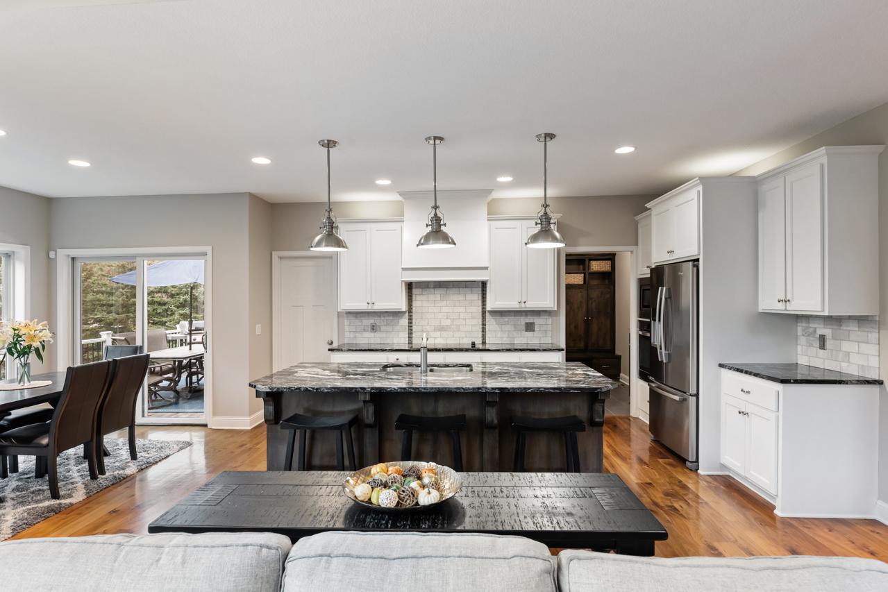 Kitchen features a large center island, a bright eating area, and convenient access to the deck.