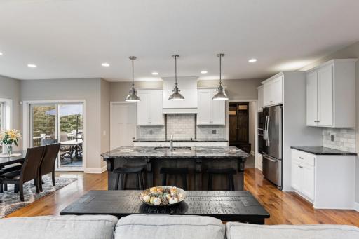Kitchen features a large center island, a bright eating area, and convenient access to the deck.