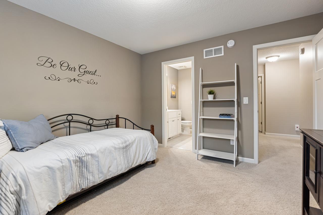 Upper-level Bedroom 2 features its own bathroom and a spacious walk-in closet.